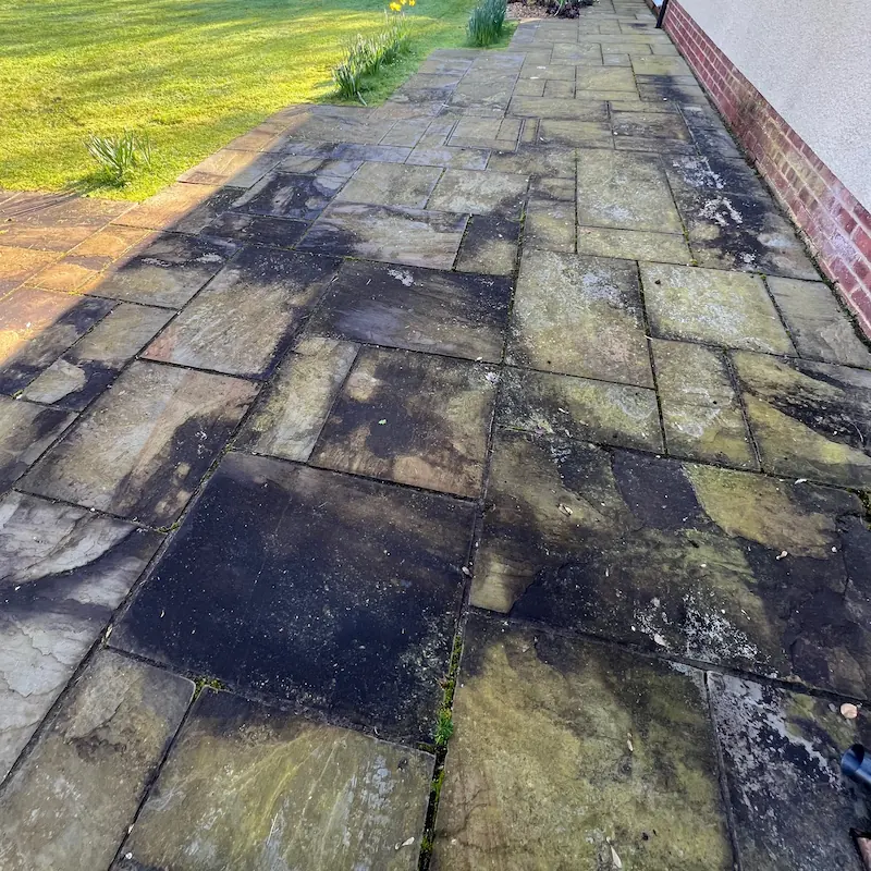Moss-covered driveway in South Wales before jet washing.